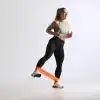 Kvinde træner med orange modstandsbånd.