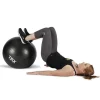 Kvinde træner med en sort fitnessbold